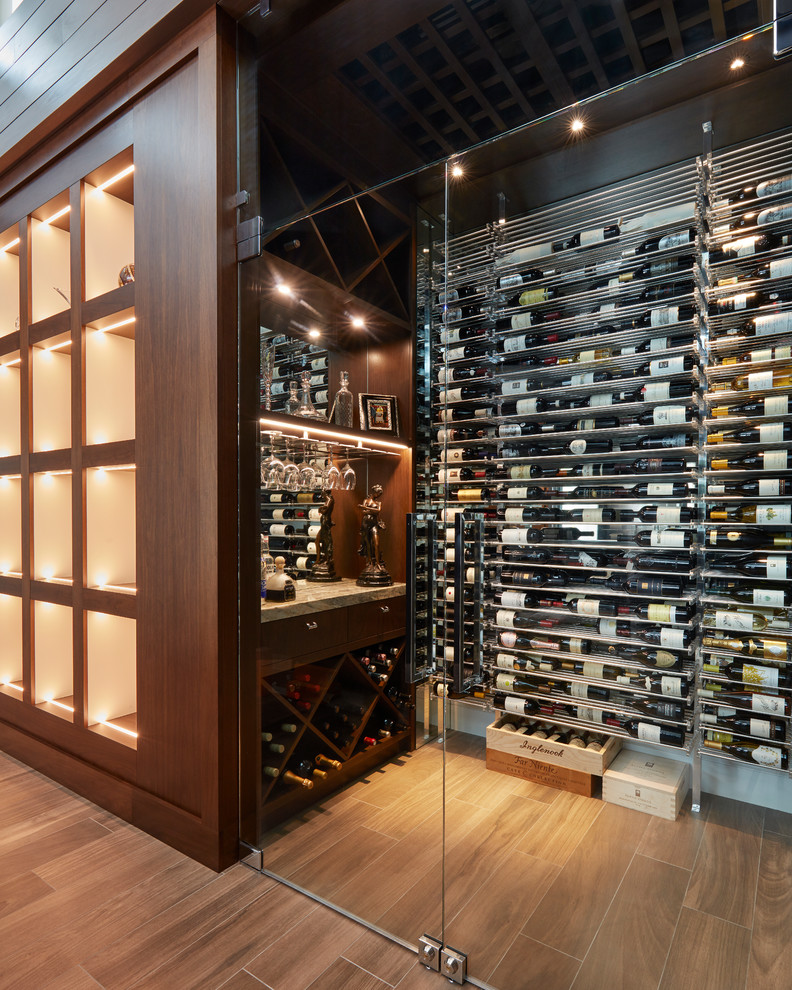 Contemporary wine cellar in Miami with dark hardwood flooring and storage racks.