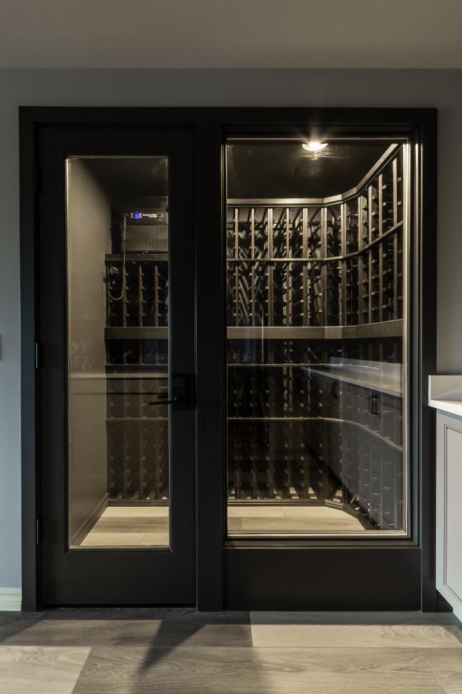 Wine cellar - contemporary medium tone wood floor and multicolored floor wine cellar idea in Seattle