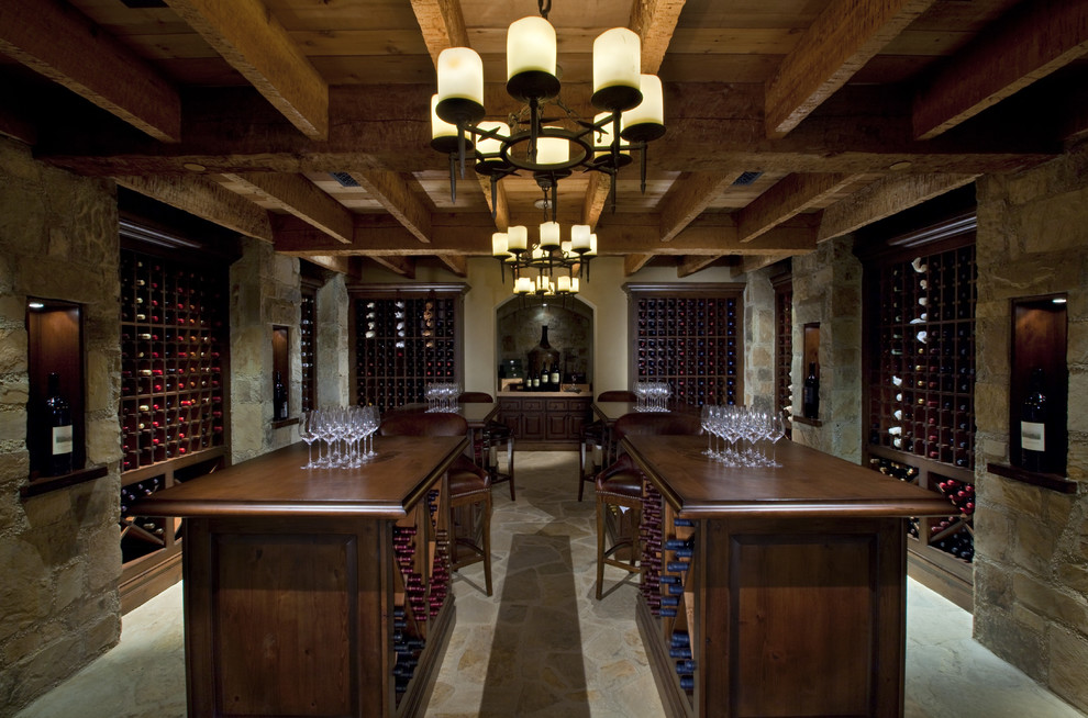 Rustic wine cellar in Austin with storage racks and grey floors.