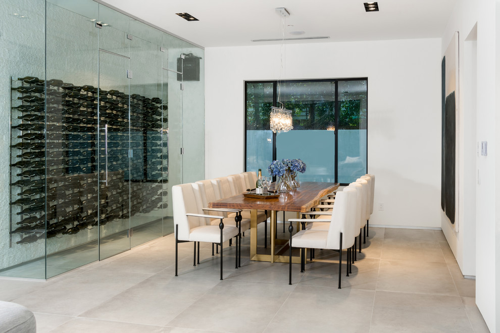 Inspiration for a medium sized contemporary wine cellar in Los Angeles with display racks and beige floors.