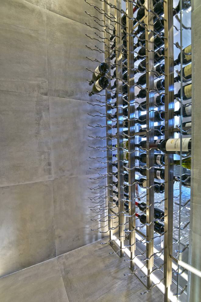 Photo of a classic wine cellar in Houston with ceramic flooring, storage racks and grey floors.