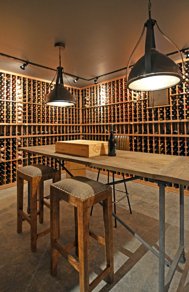 Example of a large urban concrete floor wine cellar design in Seattle with storage racks