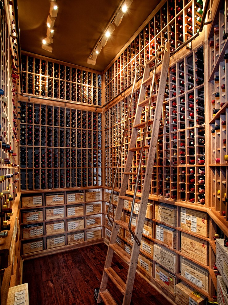 Photo of a classic wine cellar in Denver with medium hardwood flooring and storage racks.