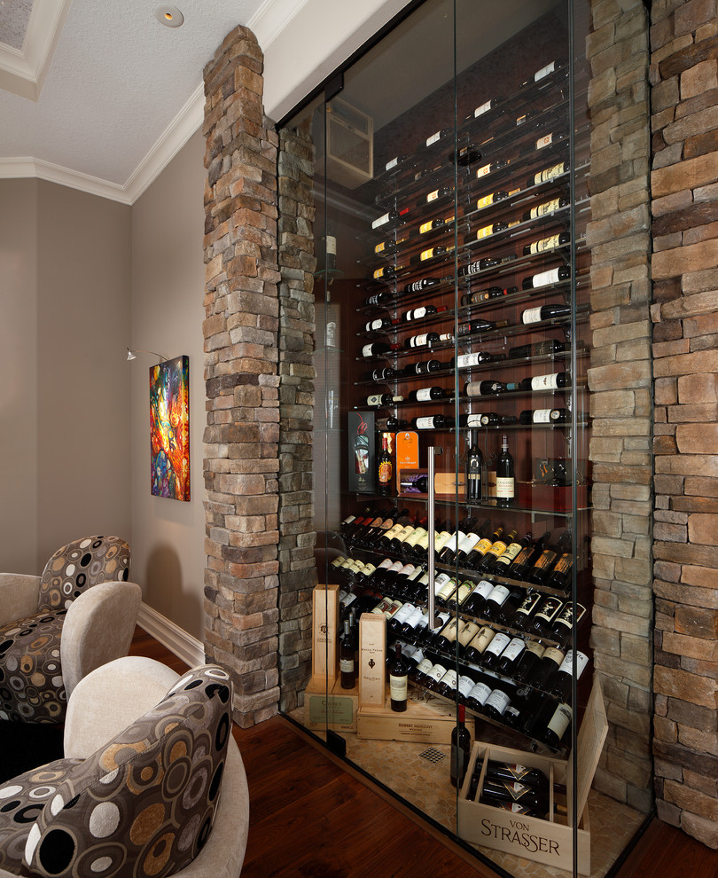 Transitional dark wood floor and yellow floor wine cellar photo in Orlando with display racks