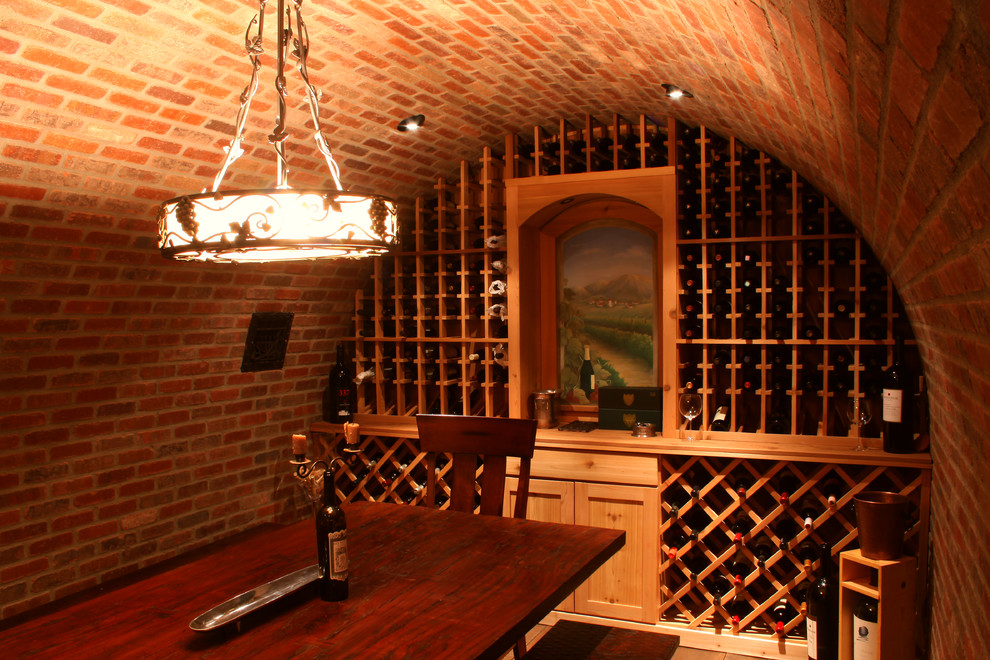 This is an example of a large traditional wine cellar in Other with storage racks.