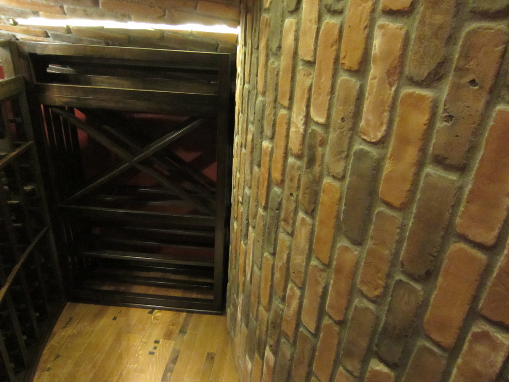 Inspiration for a mid-sized timeless medium tone wood floor wine cellar remodel in Dallas with storage racks