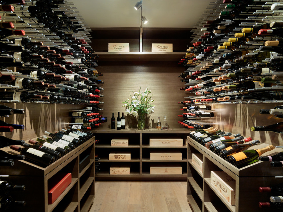 Large contemporary wine cellar in San Francisco with light hardwood flooring, storage racks and beige floors.