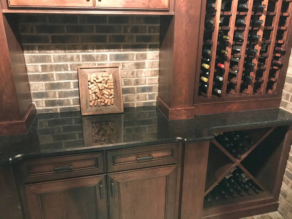 Wine cellar - small traditional ceramic tile and multicolored floor wine cellar idea in Other with storage racks