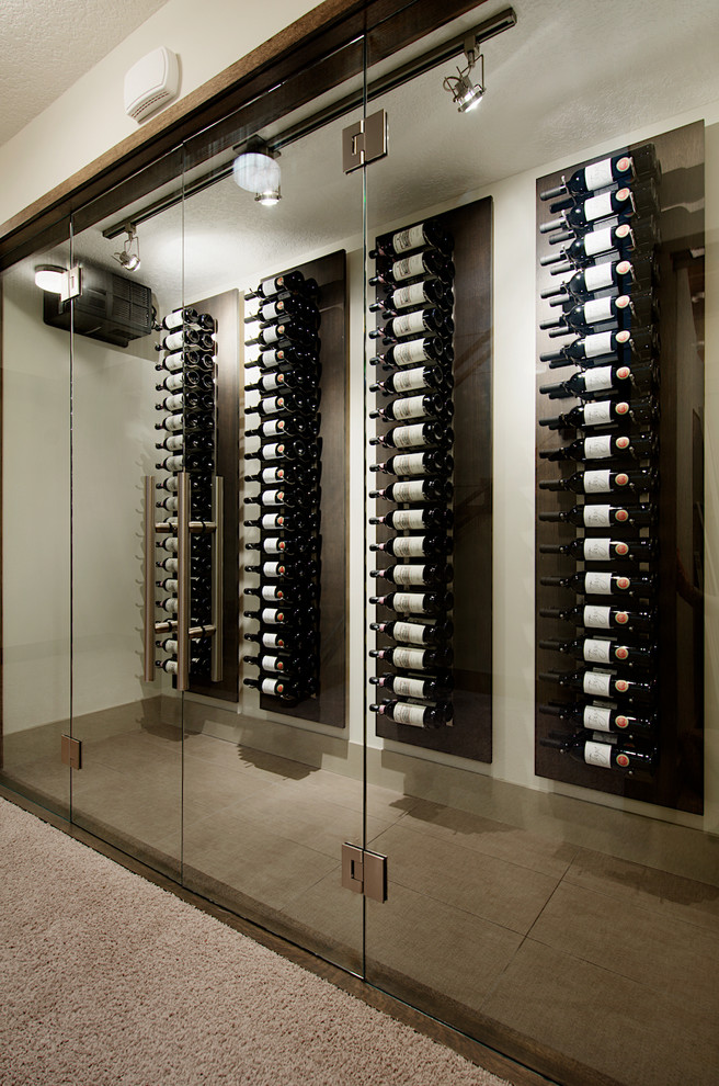 Photo of a contemporary wine cellar in Calgary with display racks.