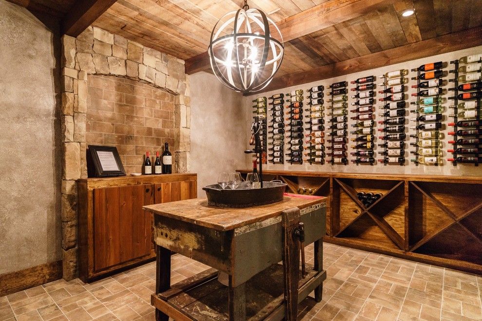 This is an example of a rustic wine cellar in Raleigh with display racks.