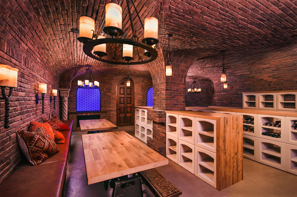 Example of a huge tuscan concrete floor and gray floor wine cellar design in Phoenix with diamond bins