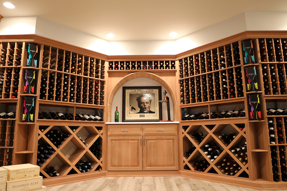 Großer Klassischer Weinkeller mit hellem Holzboden, waagerechter Lagerung und beigem Boden in New York