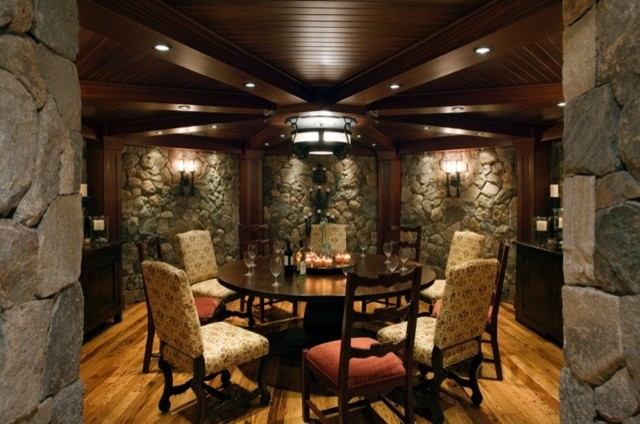 Design ideas for an expansive rustic wine cellar in Boston with light hardwood flooring and display racks.