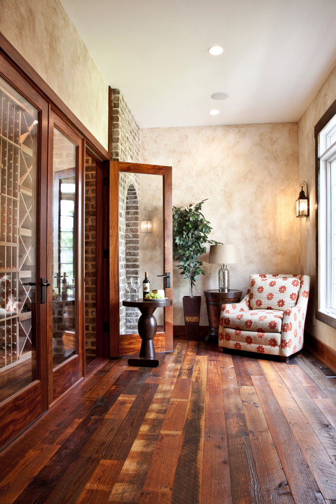 Design ideas for a rustic wine cellar in Charleston with dark hardwood flooring, storage racks and orange floors.