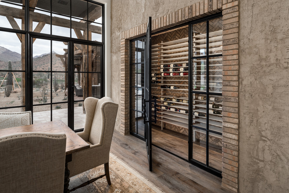 Design ideas for an expansive wine cellar in Phoenix with medium hardwood flooring, storage racks and brown floors.