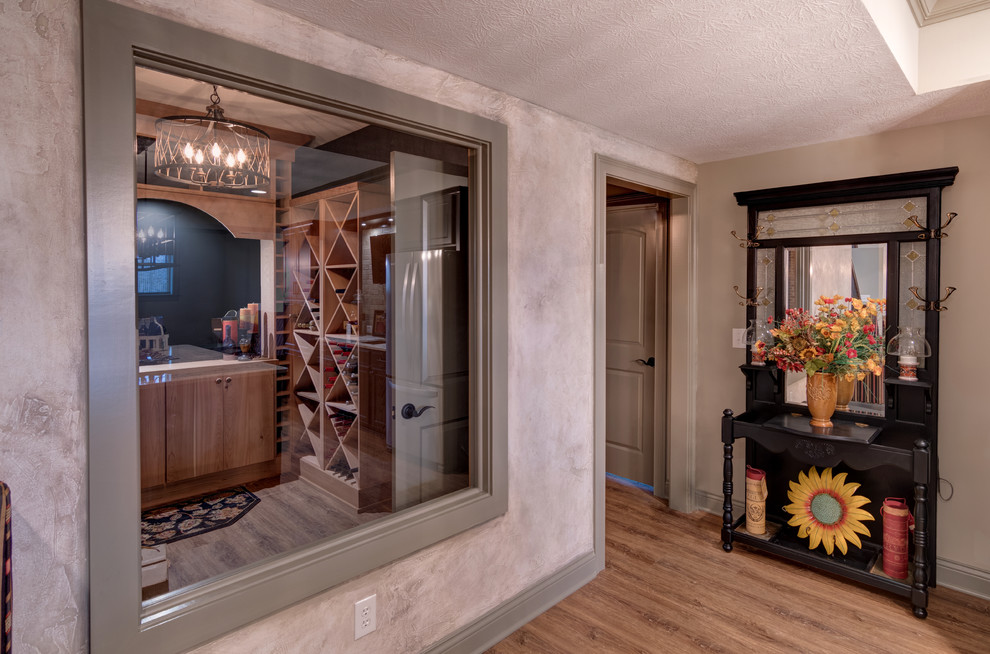 Inspiration for a large timeless light wood floor and brown floor wine cellar remodel in Indianapolis with diamond bins