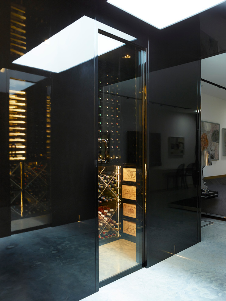 Design ideas for a medium sized contemporary wine cellar in London with grey floors, concrete flooring and storage racks.