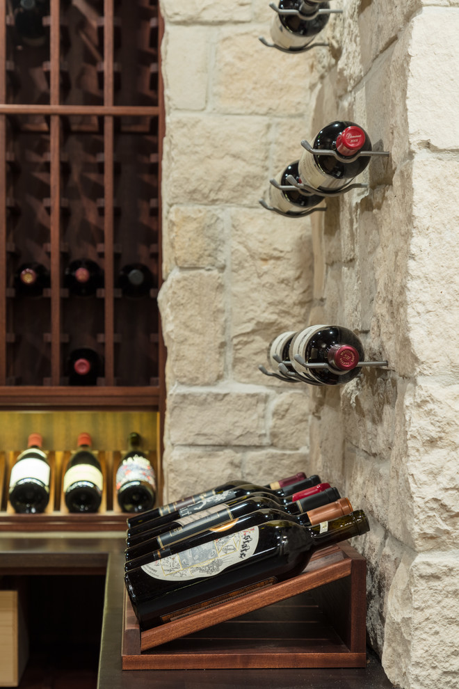 Inspiration for a mid-sized timeless travertine floor and beige floor wine cellar remodel in Boston with storage racks