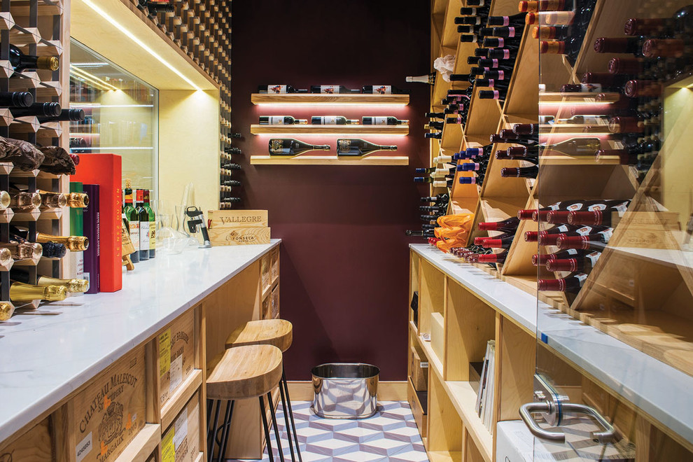 Small contemporary wine cellar in London with cube storage, ceramic flooring and multi-coloured floors.