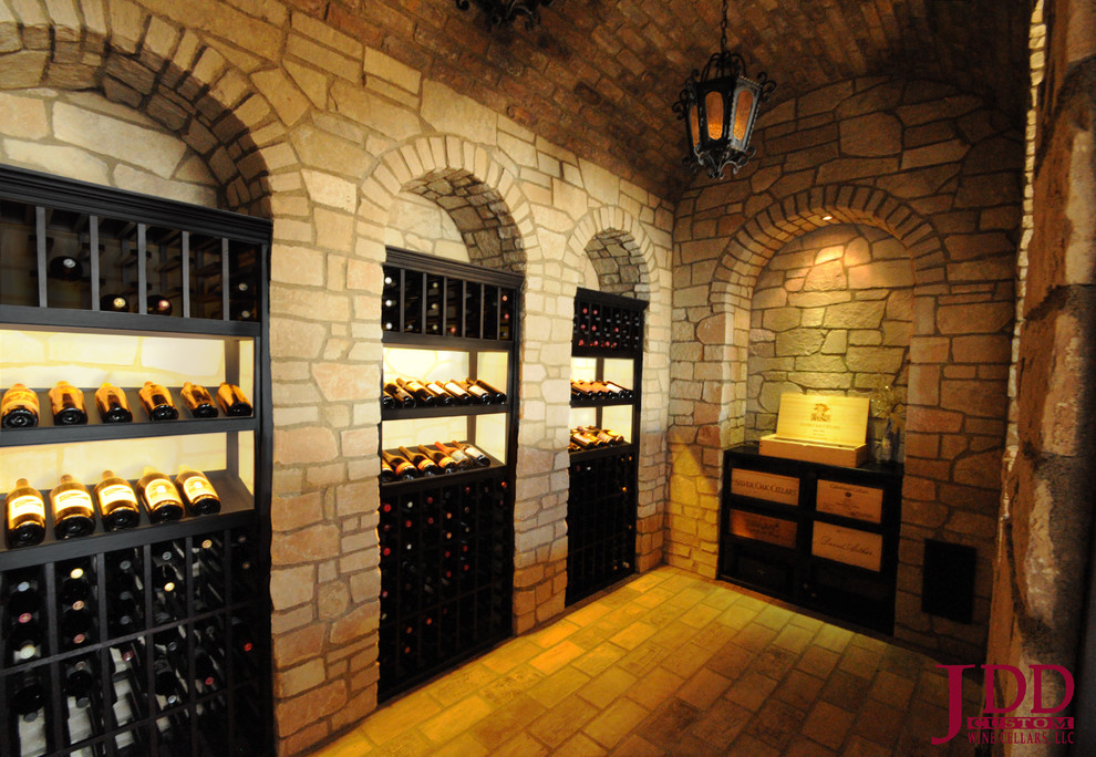 Medium sized traditional wine cellar in San Diego with travertine flooring and display racks.