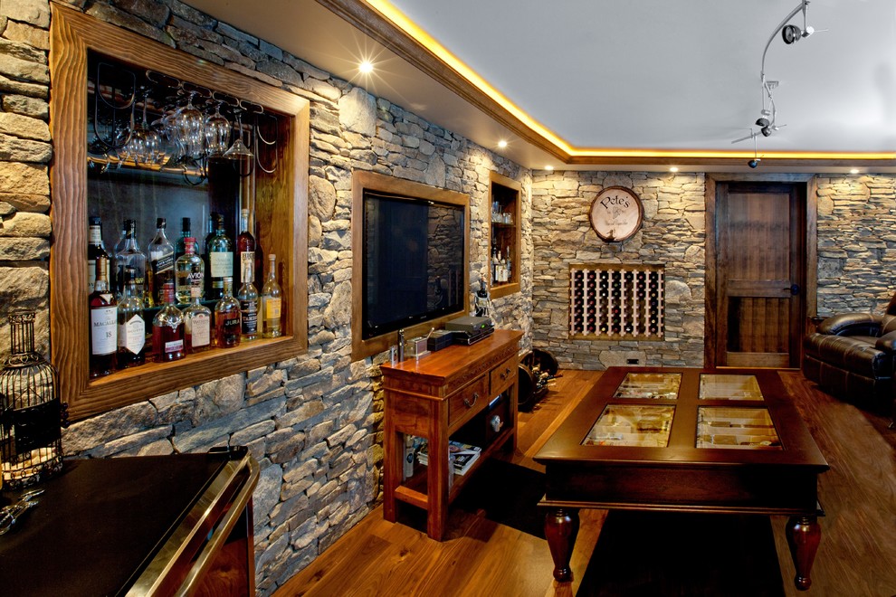 Mid-sized elegant medium tone wood floor and brown floor wine cellar photo in New York with display racks