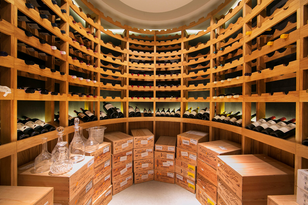 Photo of a large mediterranean wine cellar in London with storage racks.