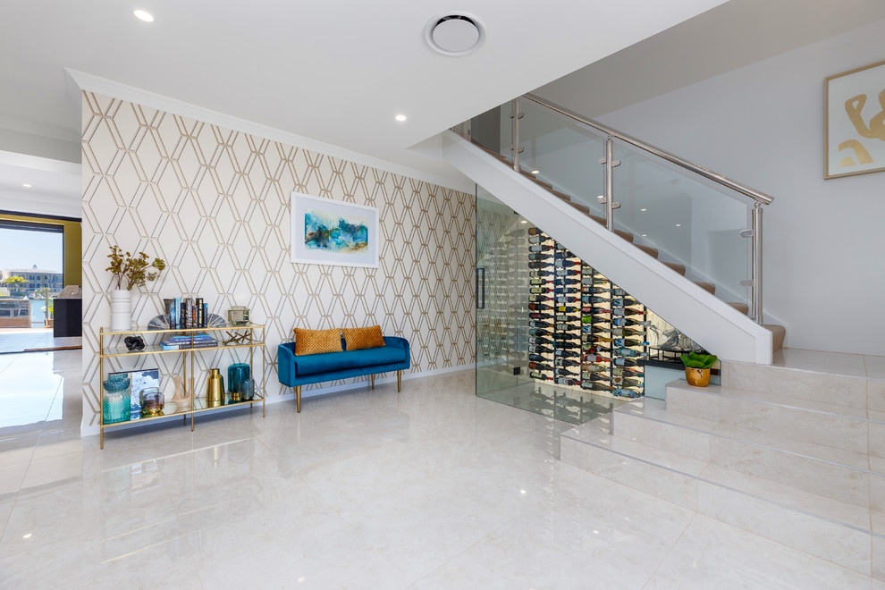 Example of a trendy beige floor wine cellar design in Brisbane with display racks