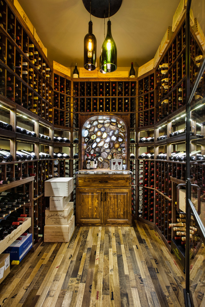 Example of a mid-sized arts and crafts dark wood floor and brown floor wine cellar design in Denver with display racks