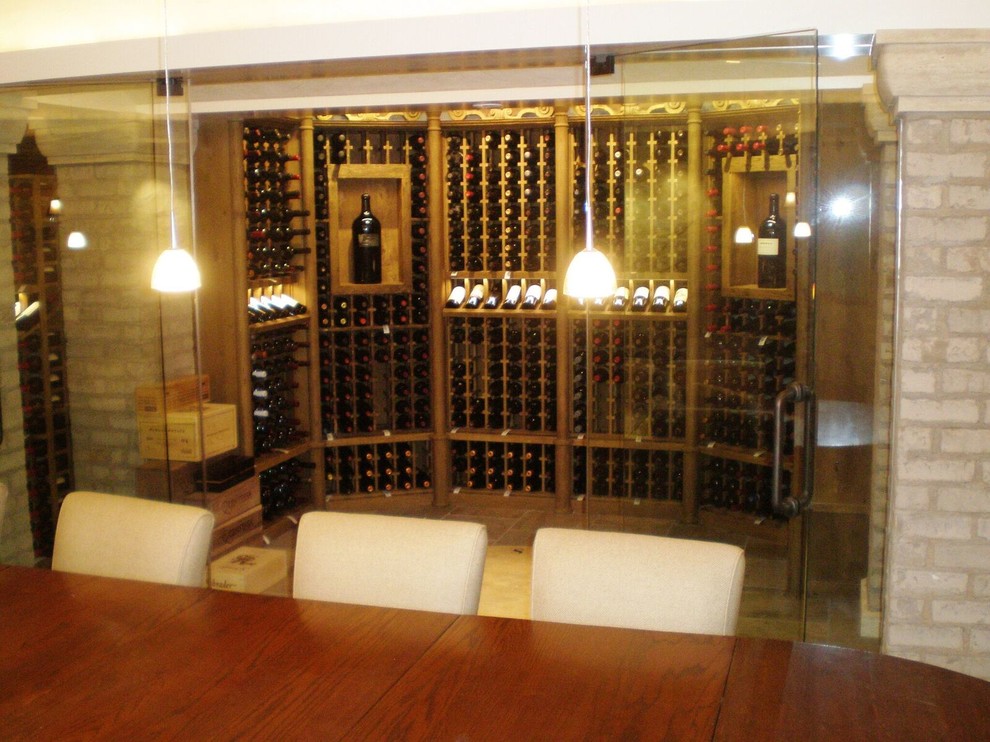 Inspiration for an expansive midcentury wine cellar in St Louis with travertine flooring and storage racks.