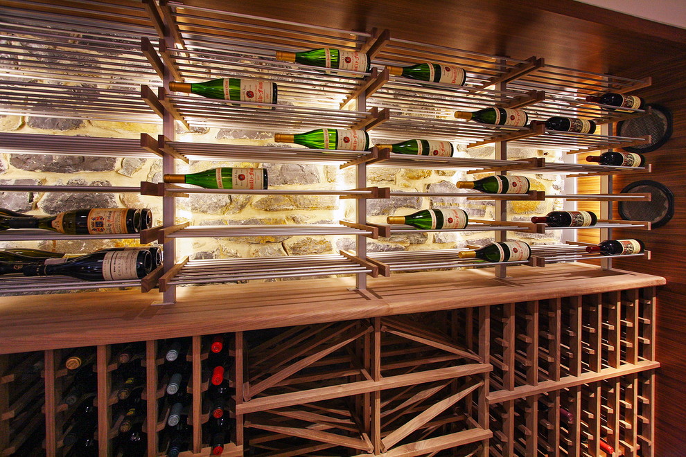 This is an example of a medium sized contemporary wine cellar in Phoenix with display racks, ceramic flooring and beige floors.