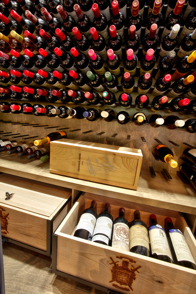 Medium sized modern wine cellar in Montreal with display racks.