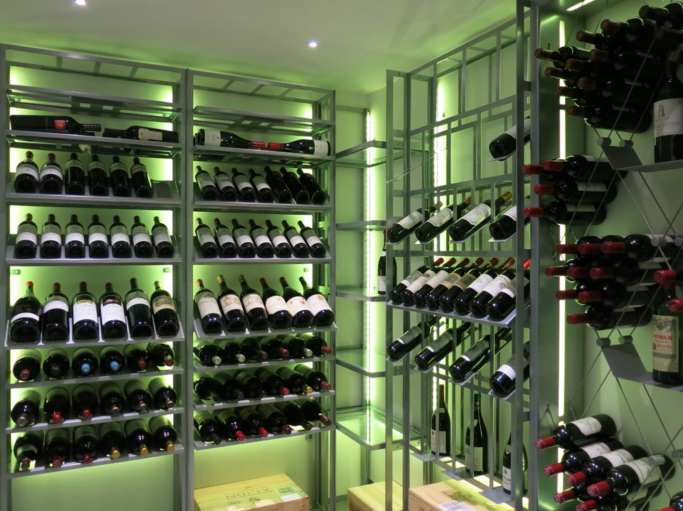 Mid-sized trendy wine cellar photo in Madrid with display racks