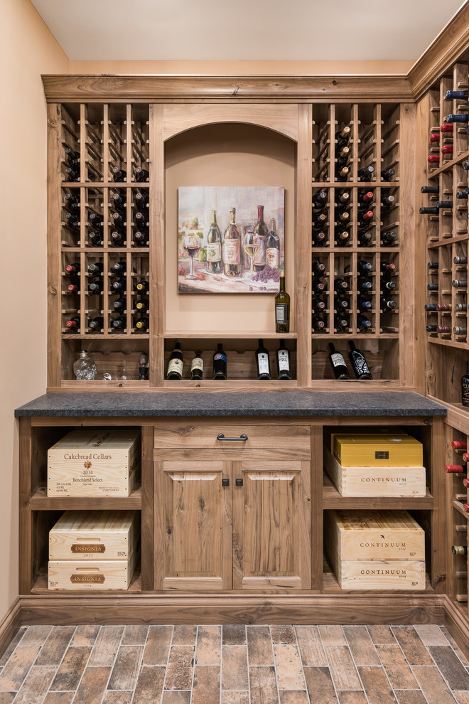 Large classic wine cellar in Chicago with storage racks and brown floors.
