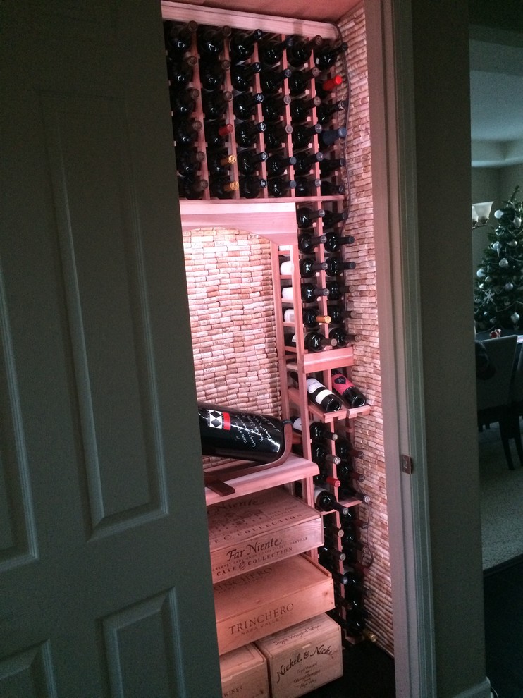 This is an example of a small contemporary wine cellar in Denver with storage racks.