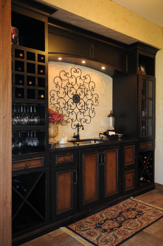 Wine cellar - mid-sized rustic ceramic tile wine cellar idea in Chicago with display racks