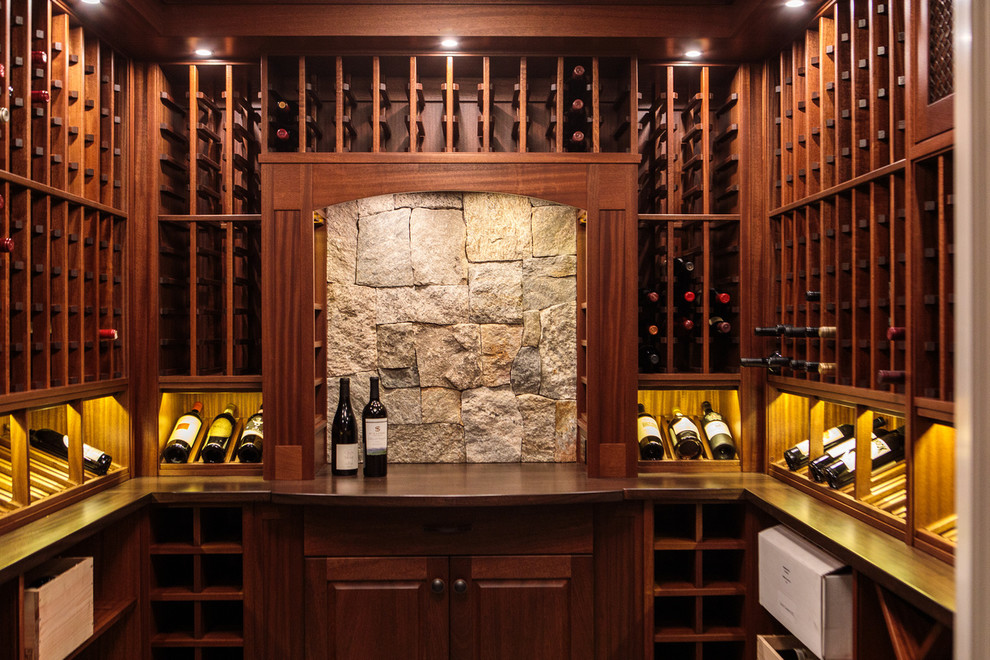 Inspiration for a medium sized traditional wine cellar in Boston with storage racks and grey floors.