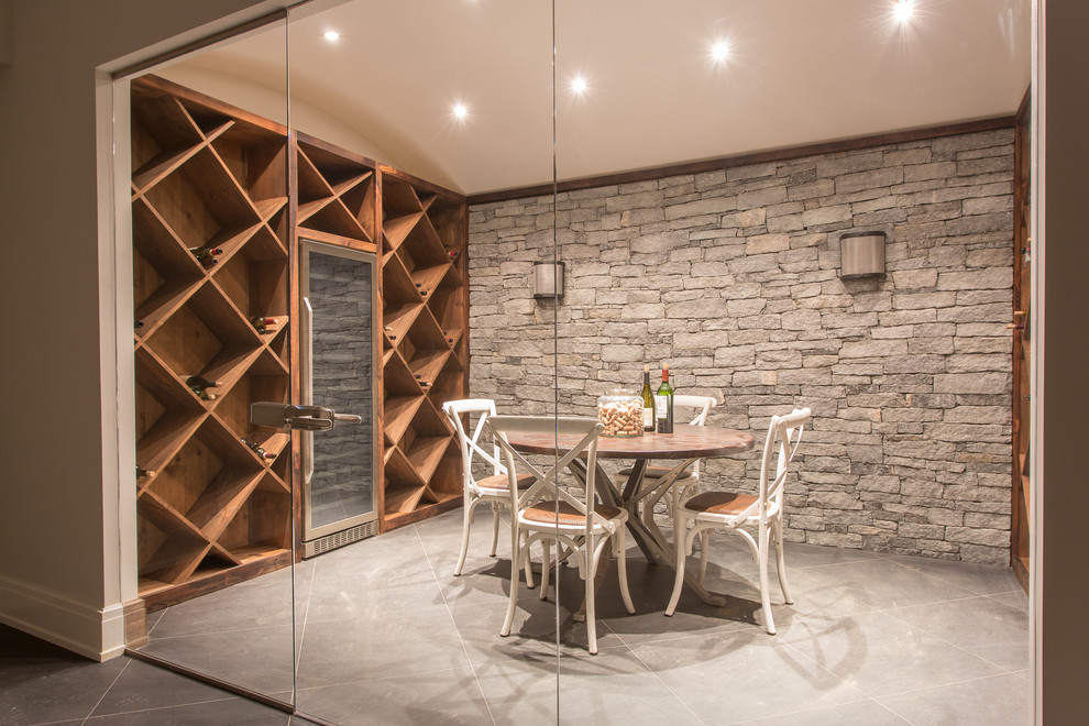 Large trendy concrete floor and gray floor wine cellar photo in New York with diamond bins