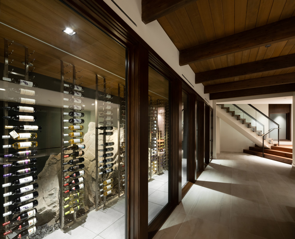 Inspiration for a mid-sized contemporary concrete floor wine cellar remodel in Other with display racks