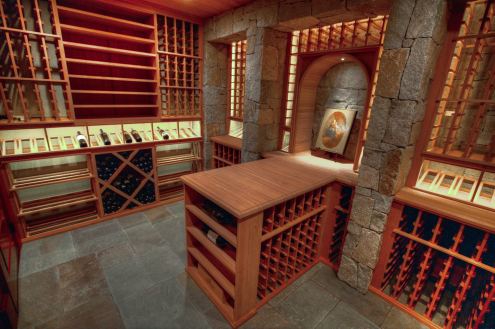 Photo of a large rustic wine cellar in Charlotte with slate flooring and storage racks.