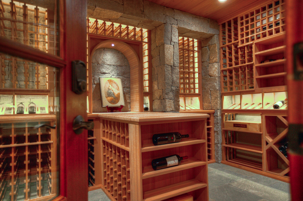 Large mountain style slate floor wine cellar photo in Charlotte with storage racks