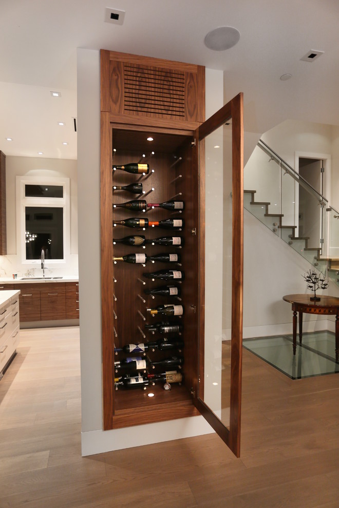 Example of a mid-sized trendy medium tone wood floor wine cellar design in Vancouver