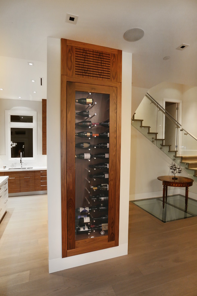 Photo of a medium sized contemporary wine cellar in Vancouver with medium hardwood flooring.