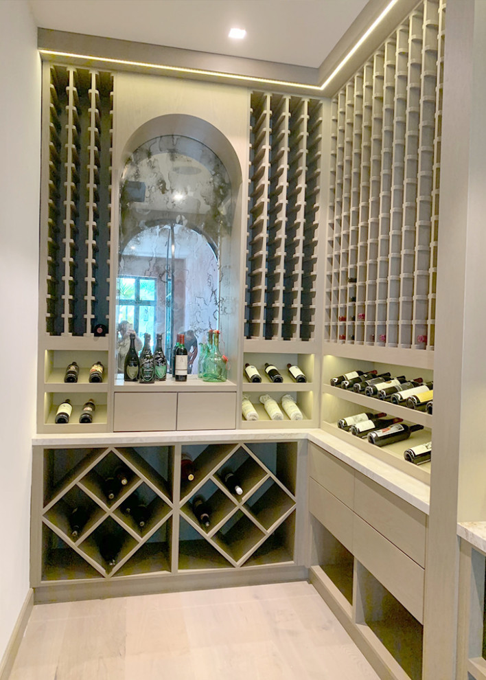 Expansive contemporary wine cellar in Miami with light hardwood flooring, cube storage and brown floors.