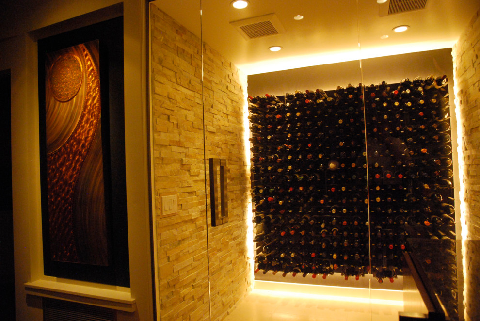 Example of a large travertine floor wine cellar design in San Francisco with display racks