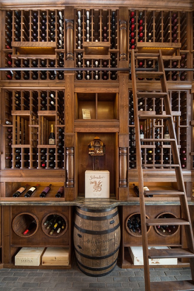 Large elegant brick floor wine cellar photo in Phoenix with storage racks