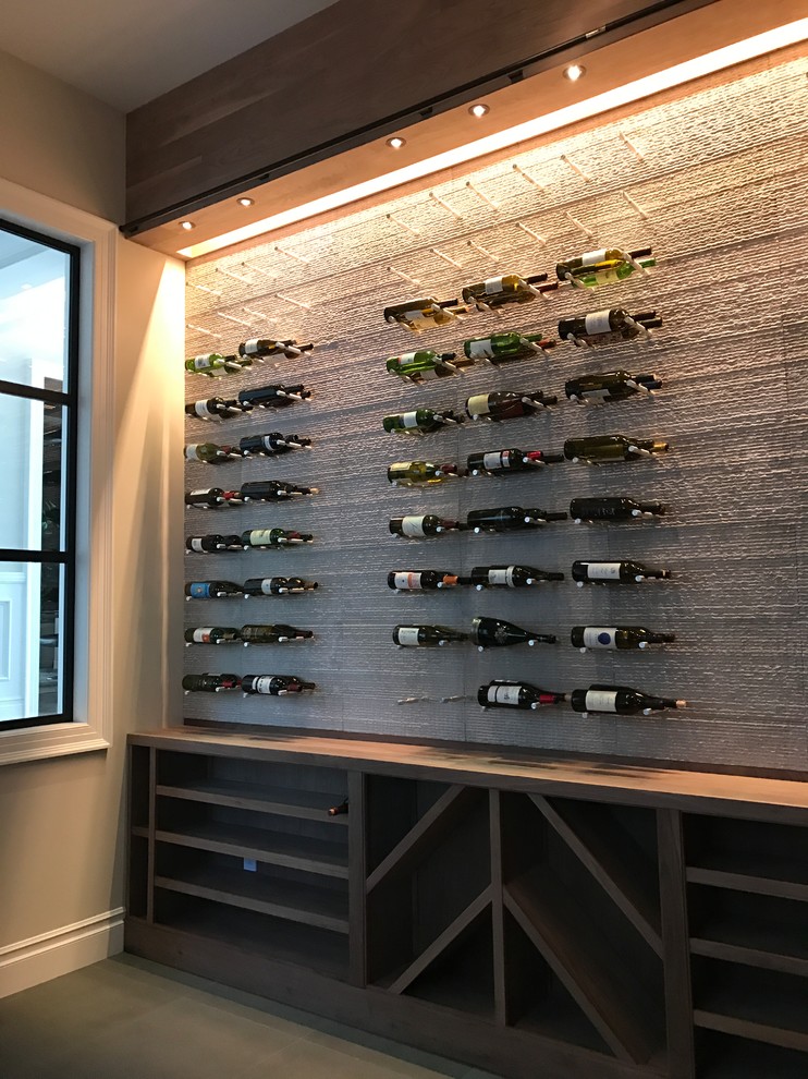 Inspiration for a large classic wine cellar in Los Angeles with slate flooring, display racks and grey floors.