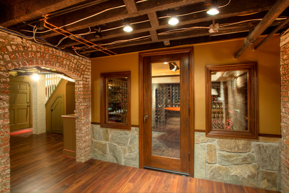 Example of a mid-sized eclectic medium tone wood floor wine cellar design in New York with storage racks
