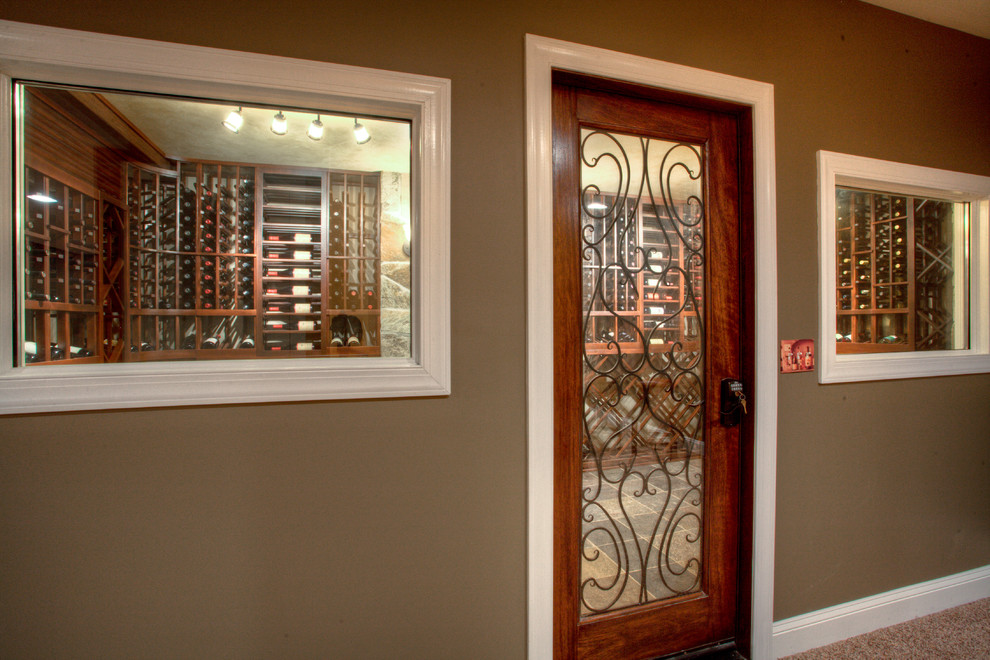 This is an example of a medium sized eclectic wine cellar in New York with storage racks.
