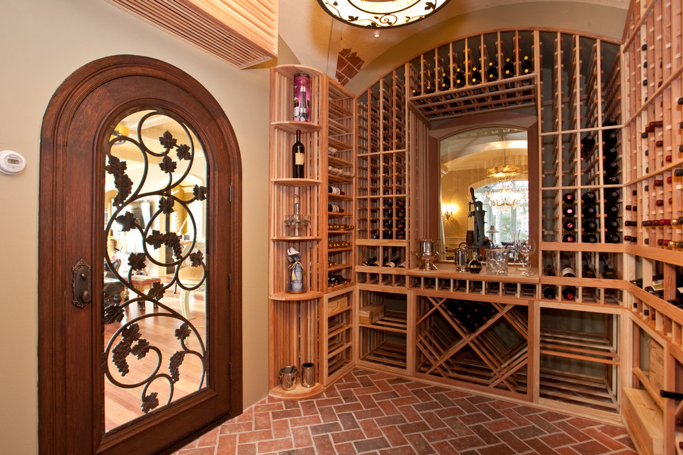 Inspiration for a mid-sized mediterranean brick floor wine cellar remodel in New York with storage racks