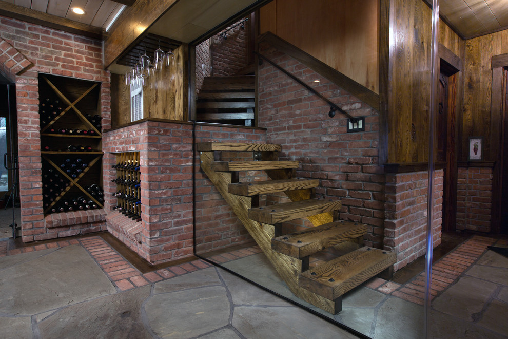 Inspiration for a large rustic gray floor and slate floor wine cellar remodel in New York with storage racks